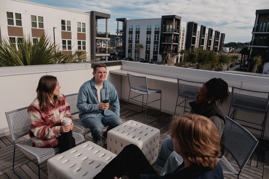 Group of friends relaxing on a rooftop patio.
